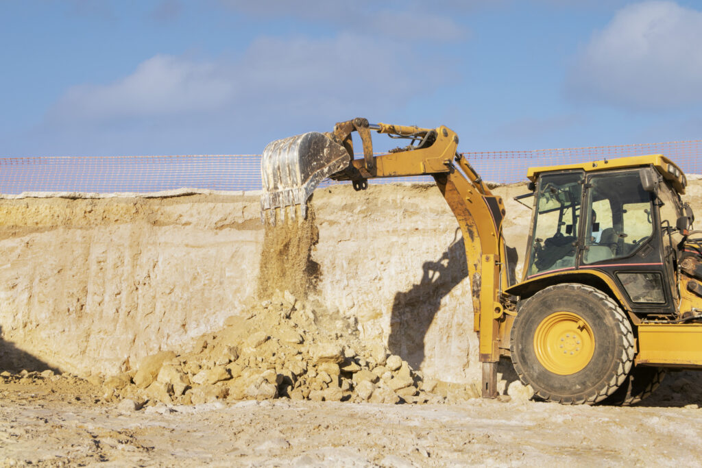 Backhoe excavator digging at construction site
